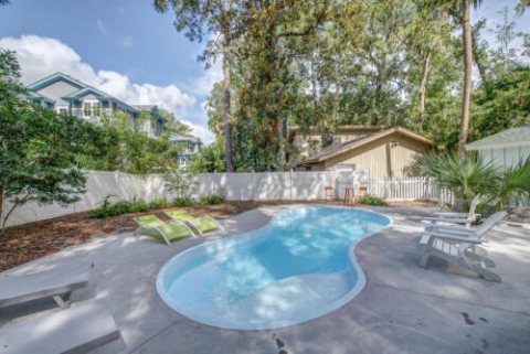 Fiberglass freeform pool in a landscaped backyard